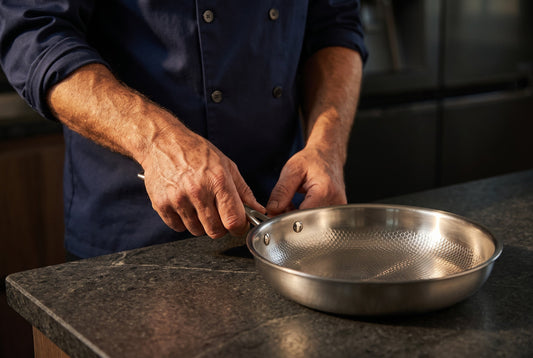 Chef holding solid titanium Chef's Pan — size guide
