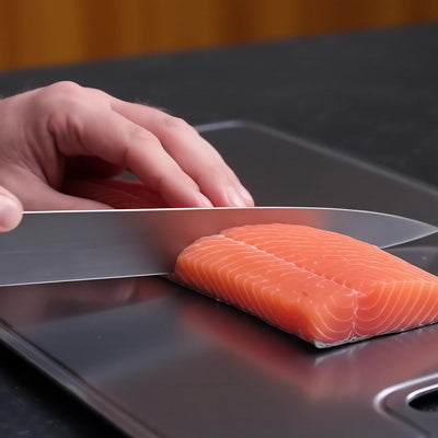 Titanoré Labs titanium cutting board — preparing salmon