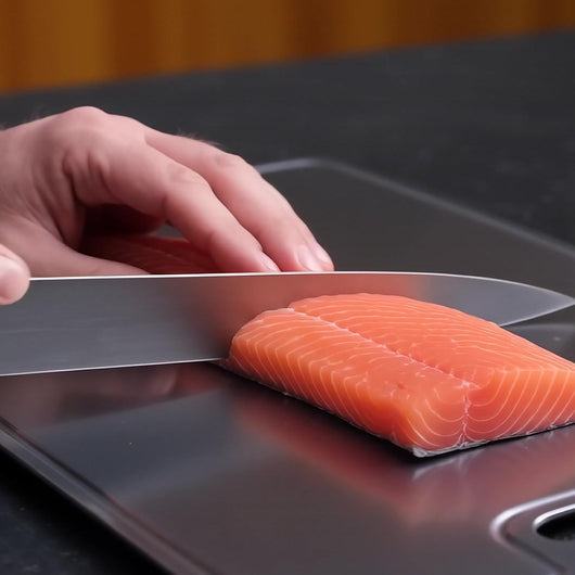 Titanoré Labs titanium cutting board — preparing salmon