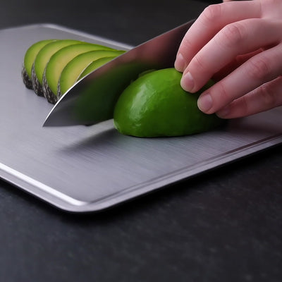 Titanoré Labs titanium cutting board — cutting avocado