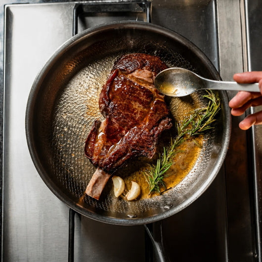 Titanoré Labs Chef's Pan — searing steak with rosemary and garlic