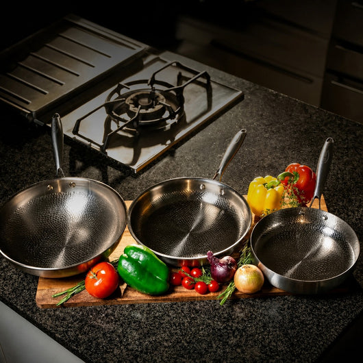Titanoré Labs Chef's Pan set — three pans with fresh vegetables