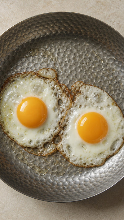 Chef's Pan with sunny-side-up eggs — solid titanium, overhead
