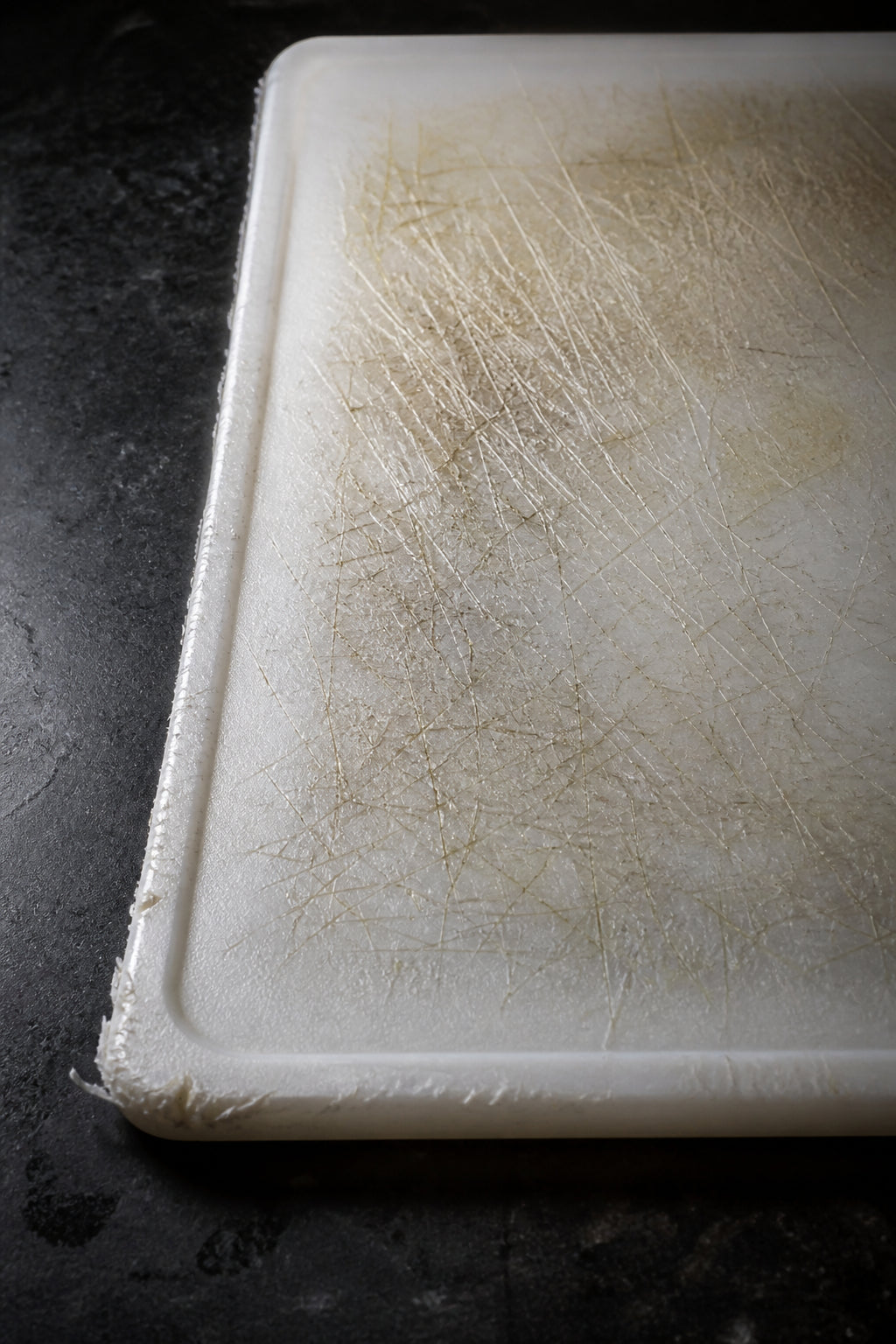 Worn plastic cutting board surface