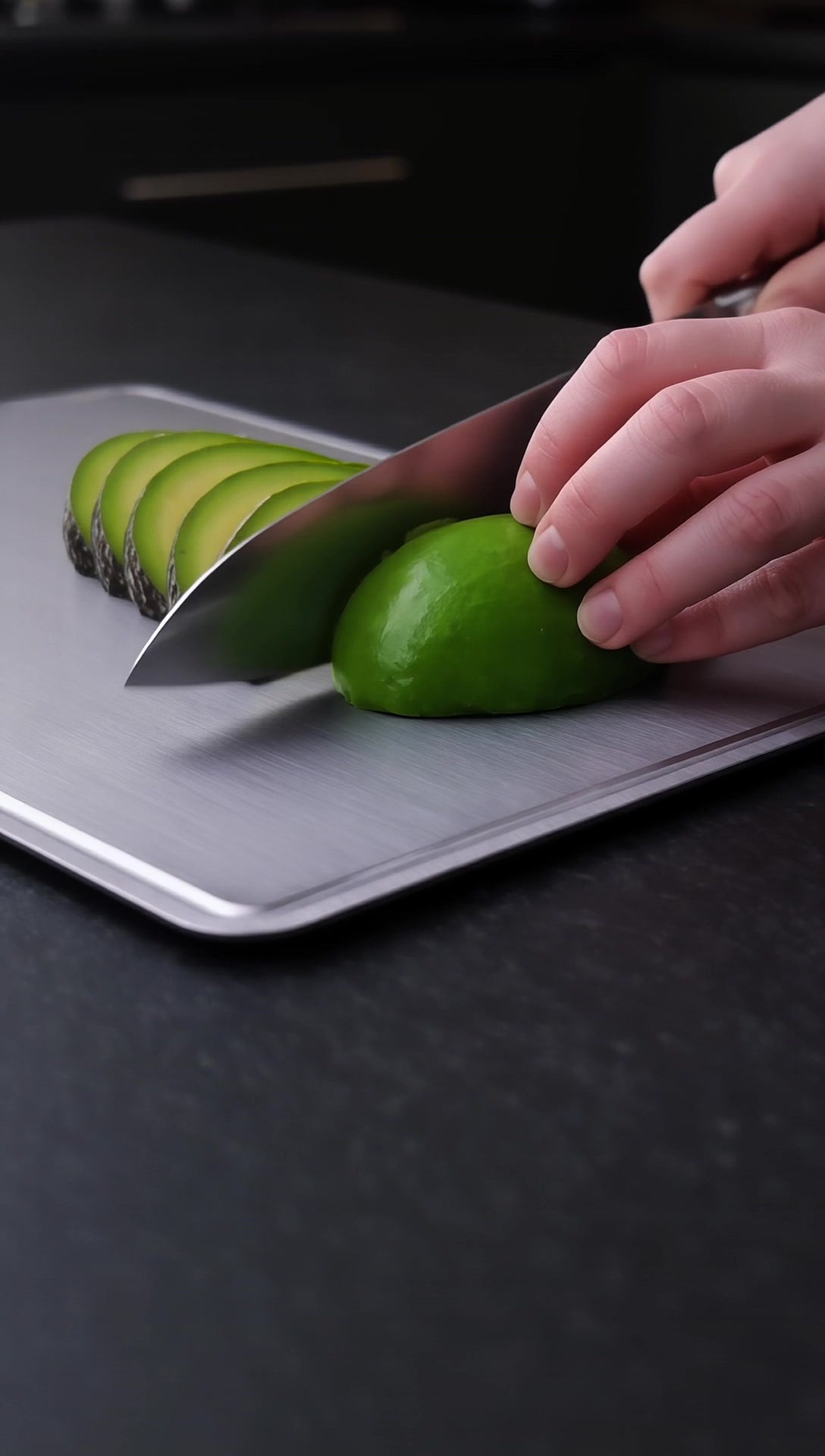 Cutting avocado on titanium board